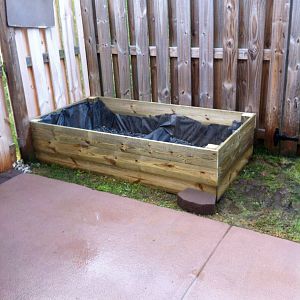 wood planter with stone face