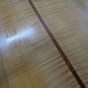 book matched curly veneer with an inlay in the middle.