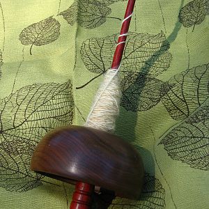 Drop spindle with a cupped whorl