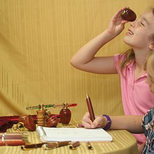 Children eagerly use the artist pencil and kaleidoscopes